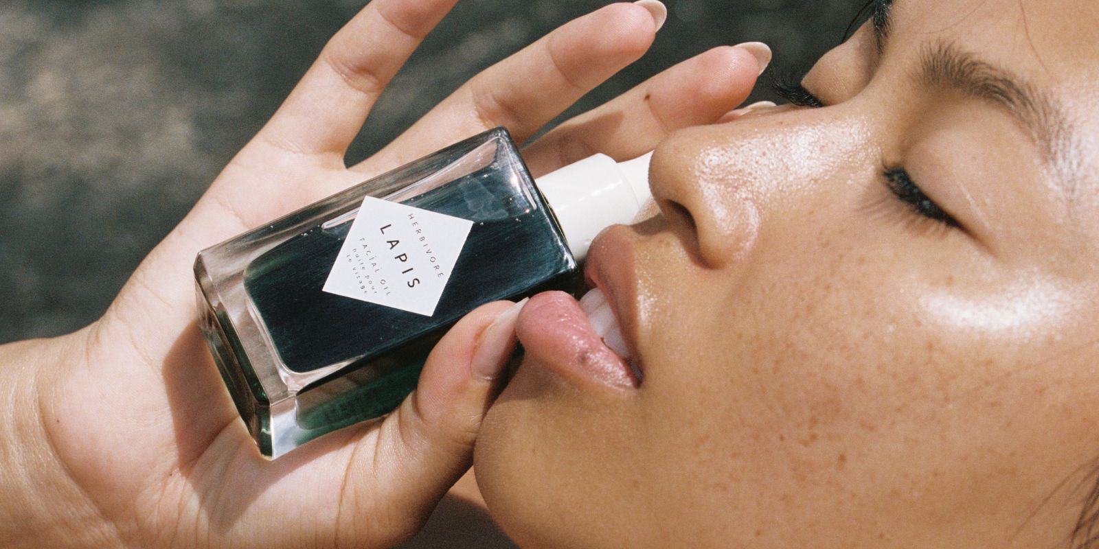 Woman holding LAPIS facial oil